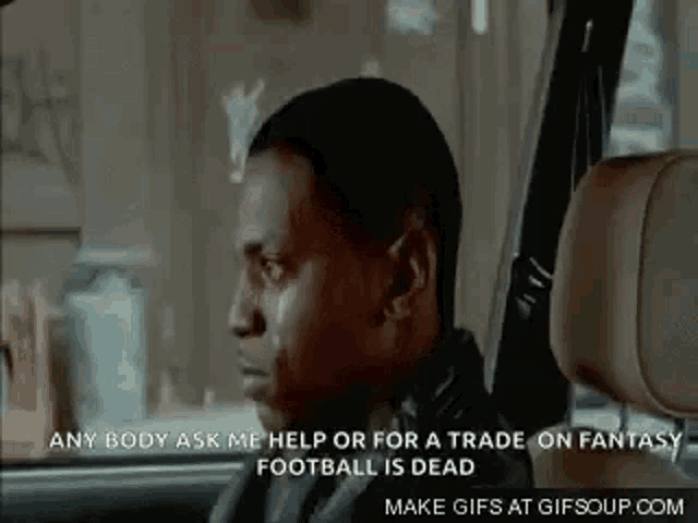 a man is sitting in the driver 's seat of a car and crying .