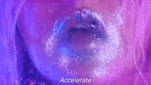 a close up of a woman 's mouth with water coming out of it and the words accelerate written above it .