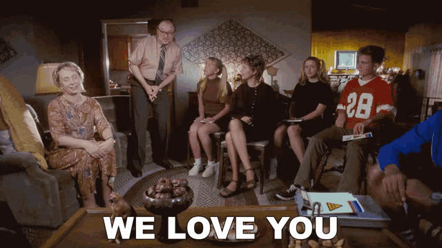 a group of people sitting in a living room with the words " we love you " on the bottom