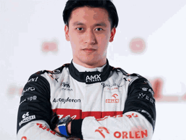 a man in a racing suit with the word orlen on the sleeve