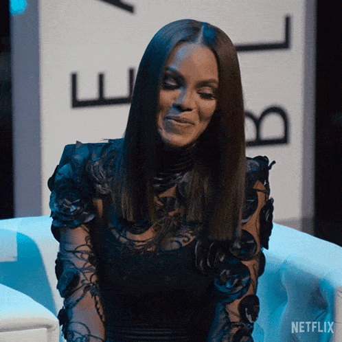 a woman sitting in front of a netflix sign