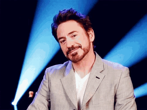 a man with a beard wearing a suit and a white shirt