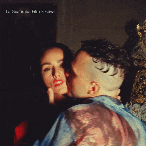 a man kissing a woman on the cheek with la guarimba film festival written on the bottom