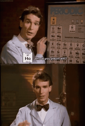 a man in a lab coat points to a periodic table and says who iz you playin wit