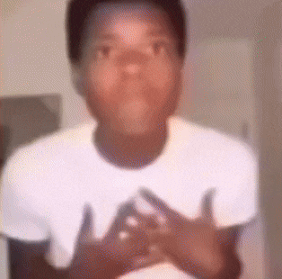 a young boy is wearing a white t-shirt and making a funny face .