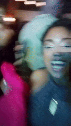 a blurry picture of a woman 's face with a nike logo on her chest