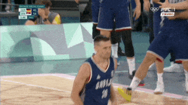a basketball player in a blue jersey with the number 18