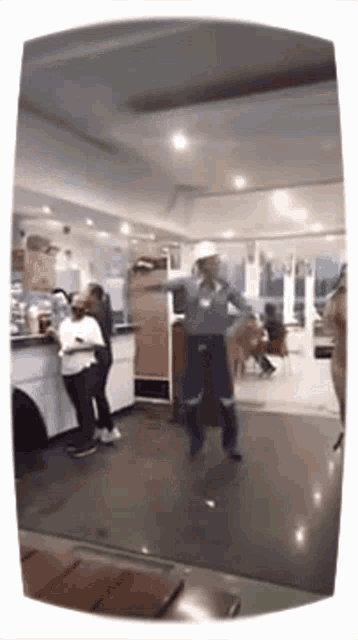 a man in a hard hat is standing on stilts in a room .