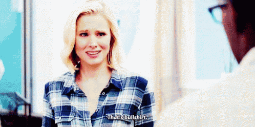 a woman in a plaid shirt is talking to a man and says `` that 's bullshit . ''