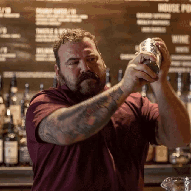 a bartender prepares a drink in front of a menu that says " house pub "