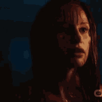 a close up of a woman 's face with blood dripping from it .