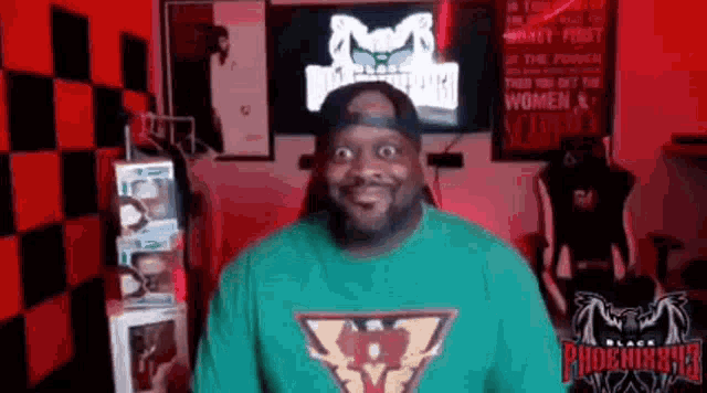 a man with a beard is wearing a green shirt and a baseball cap .