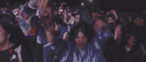 a crowd of people are dancing at a concert in a club .
