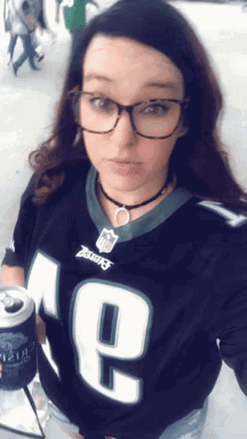 a woman wearing a philadelphia eagles jersey