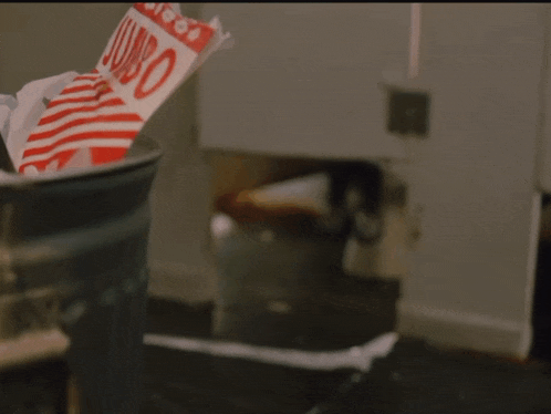 a bag of jumbo candy sits in a trash can