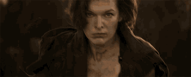 a close up of a woman 's face with a black spot on her forehead