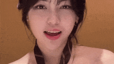 a close up of a woman 's face with her mouth open and a tie around her neck .