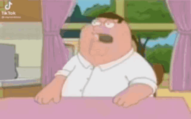 peter griffin from family guy is sitting at a table in front of a window with his mouth open .