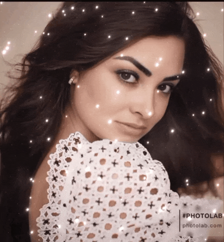 a woman in a white lace top is surrounded by snowflakes and the website photolab.com