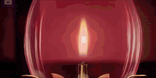 a close up of a candle in a glass container