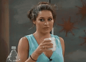 a woman is drinking water from a bottle that says aquafina on it