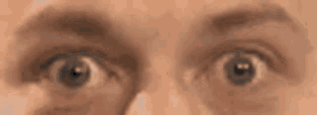 a close up of a person 's eyes looking at the camera