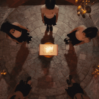a group of people standing in a circle around a table