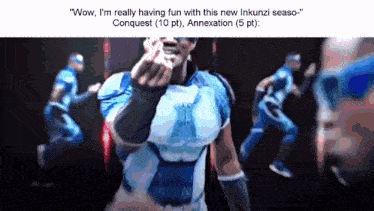 a man in a superhero costume is pointing at the camera