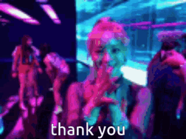 a woman is holding a microphone in front of a crowd and says thank you