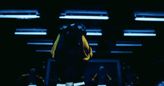a blurred image of a person in a dark room with lights on