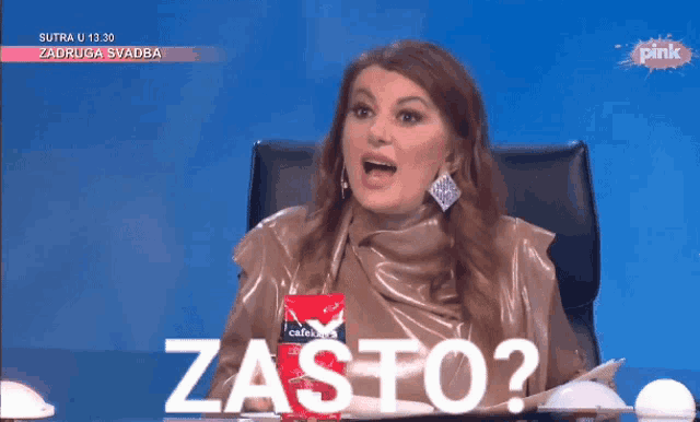 a woman sitting at a table with a bag of coffee and the word zasto on the screen