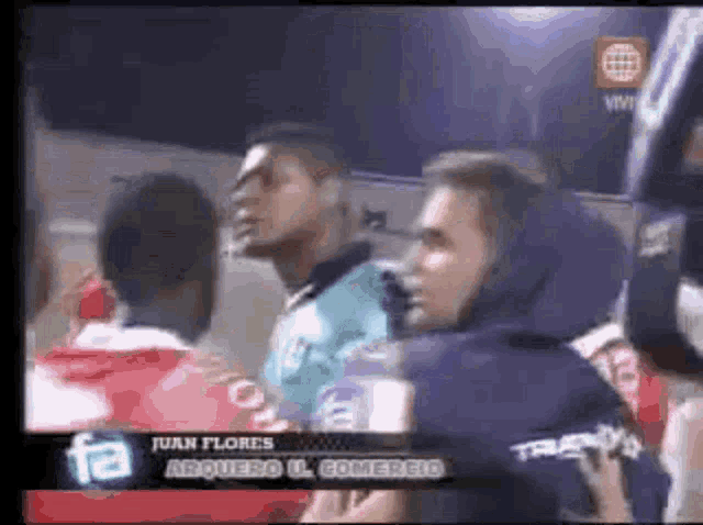 a group of people are watching a soccer game between juan flores and arquero