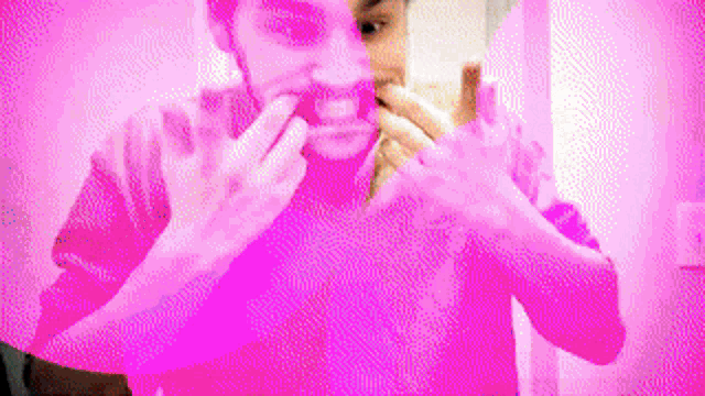 a man is brushing his teeth in front of a mirror