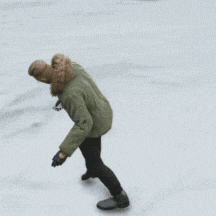 a person in a green parka is ice skating