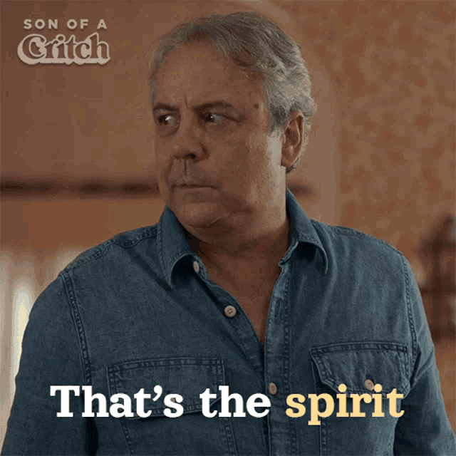 a man in a denim shirt with the words that 's the spirit above him