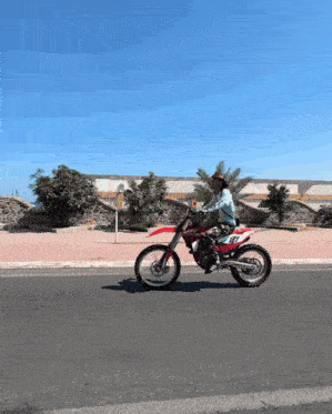 a person riding a dirt bike with the number 87 on it