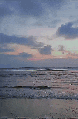 a beach at sunset with waves crashing on the shore