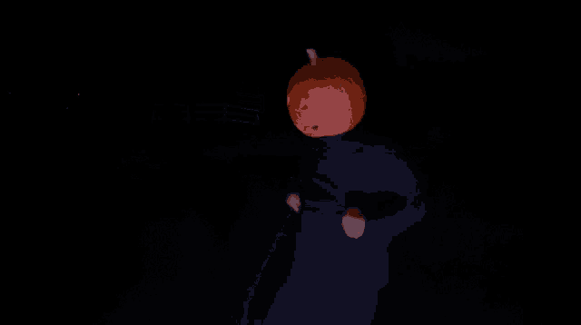 a man with a carved pumpkin on his head is dancing in the dark