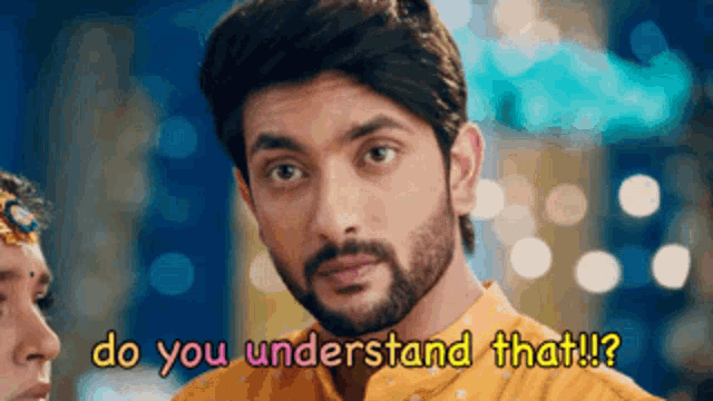 a man with a beard is looking at a woman and says " do you understand that "