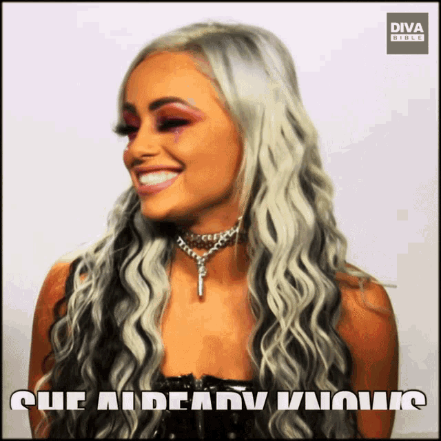 a woman with long white hair is smiling in front of a diva bible logo
