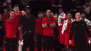 a group of basketball players wearing red jerseys with the number 23 on them