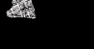 a black corvette is sitting on a white surface .
