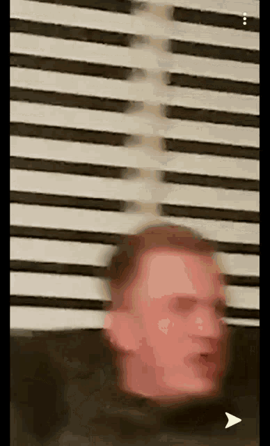a blurry picture of a man 's face with an arrow pointing to the left .