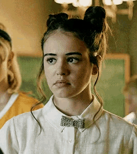 a girl wearing a bow tie and a white shirt
