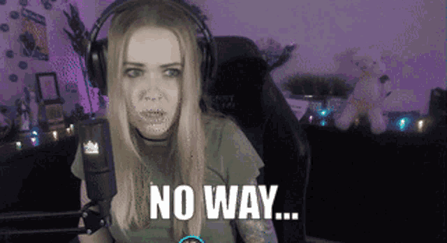 a woman wearing headphones is sitting in front of a microphone and says no way