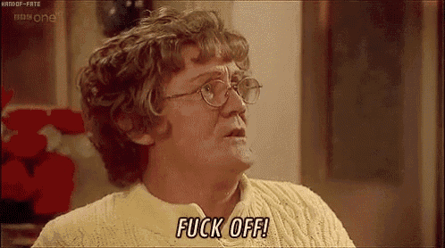 a man wearing glasses and a yellow sweater is saying `` fuck off ! ''
