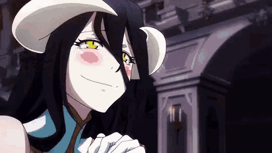 a girl with long black hair and horns is smiling and looking at the camera .