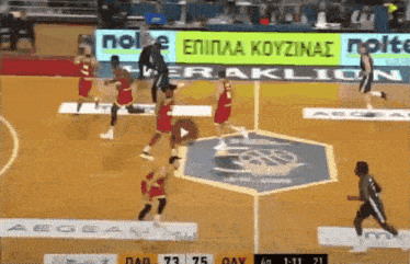 a group of basketball players are playing on a court with a sign that says aegean
