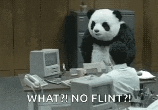 a panda bear is standing in front of a man sitting at a desk in an office .