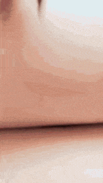 a close up of a woman 's arm with a ring on it .